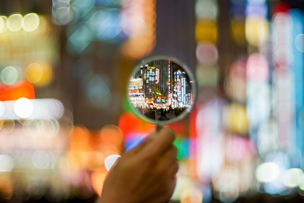 colourful city scape with mag glass, decorative only